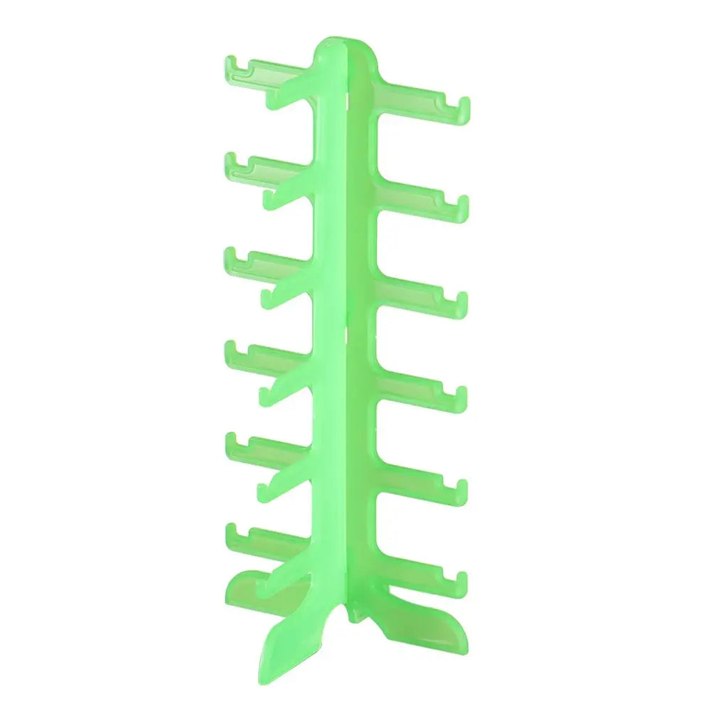 A bright green stackable display stand for holding sunglasses and reading glasses.