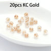 20 pieces of gold silicone rubber ear back stoppers with copper rings displayed on a white plate.