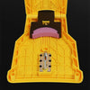 A yellow portable chainsaw sharpener tool with a black holder and purple whetstone insert.