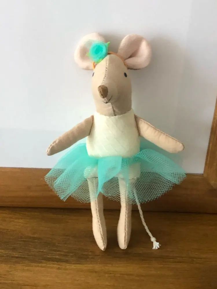 A stuffed rabbit toy with light brown fur, pink ears, and a turquoise tulle skirt.