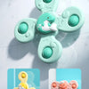 A light mint green suction cup spinner bath toy shaped like a duck, floating on a white marble surface.