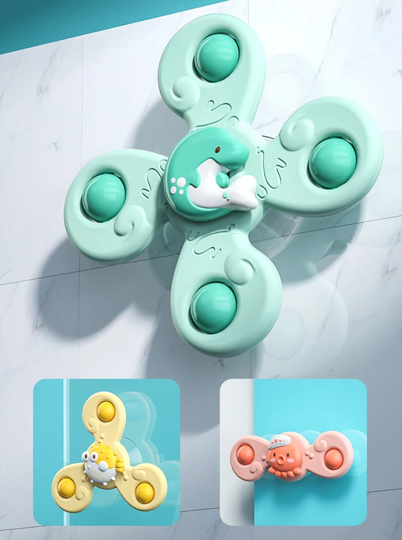 A light mint green suction cup spinner bath toy shaped like a duck, floating on a white marble surface.