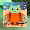 A wooden owl puzzle featuring bright orange and teal colors against a blue starry background.