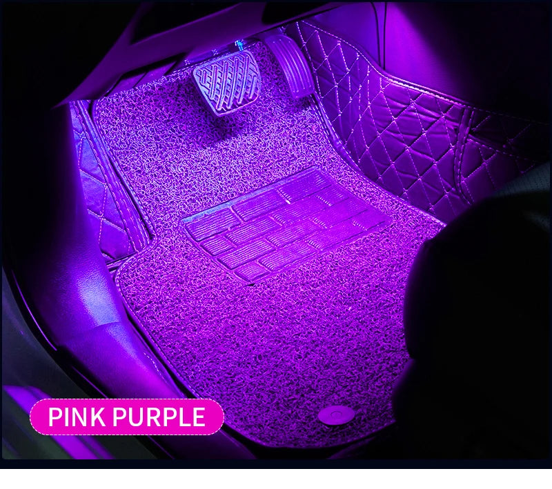 Pink purple RGB LED ambient light illuminating a car interior with a keyboard and surrounding leather upholstery
