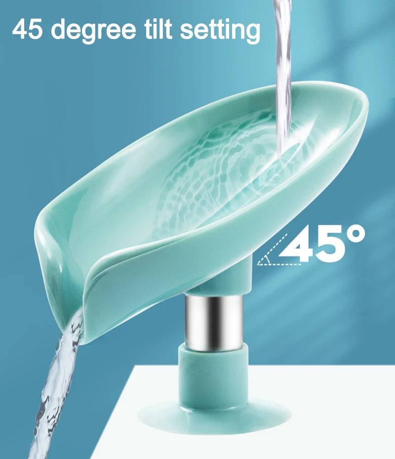 A teal leaf-shaped soap dish with a 45 degree tilt setting is shown dripping water.