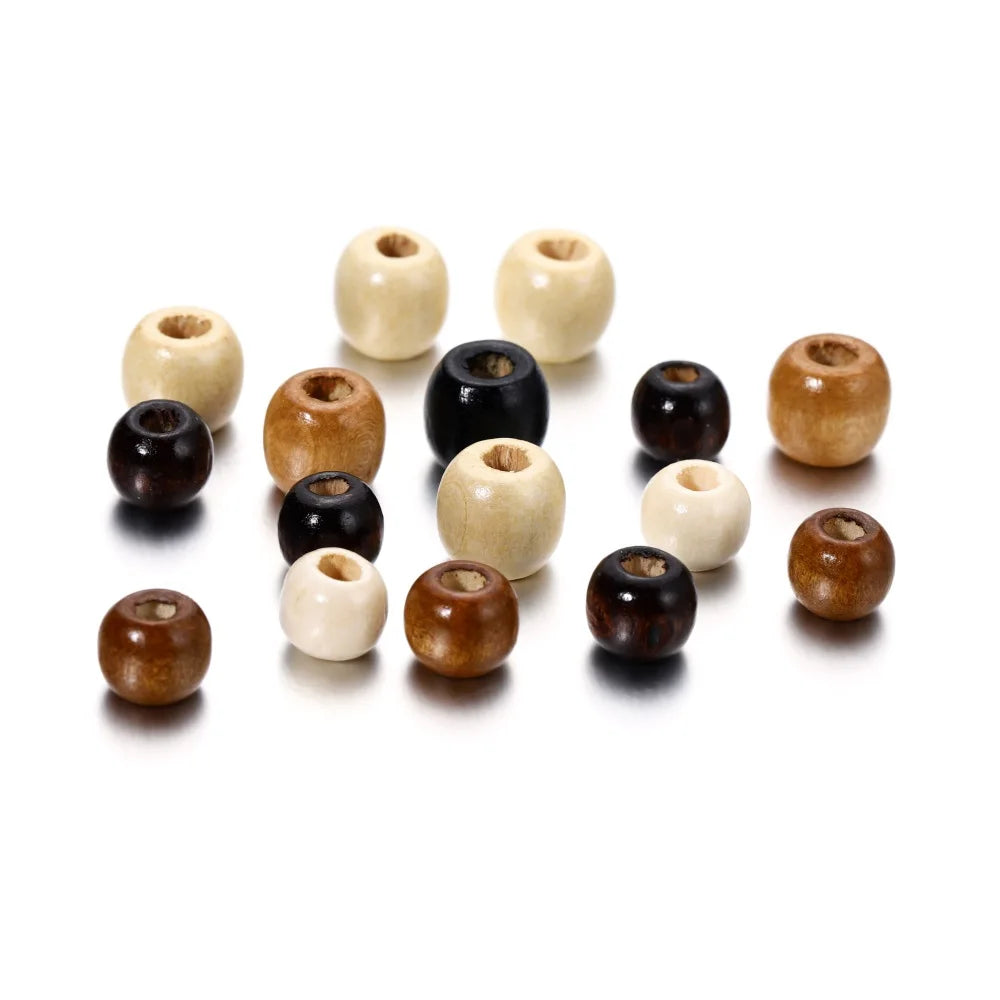 A collection of natural wooden spacer beads in various light and dark wood tones arranged on a white background.