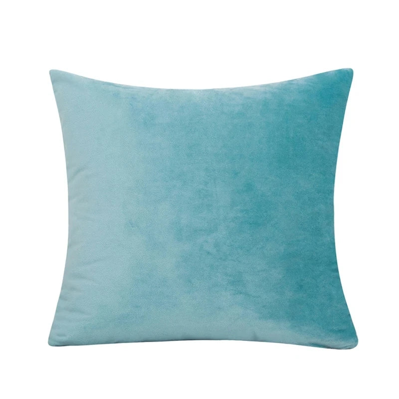 A solid teal velvet decorative cushion cover pillow.