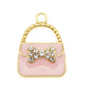 A set of six crystal enamel handbag charm pendants featuring a gold-toned loop and a pink square with a bow detail.