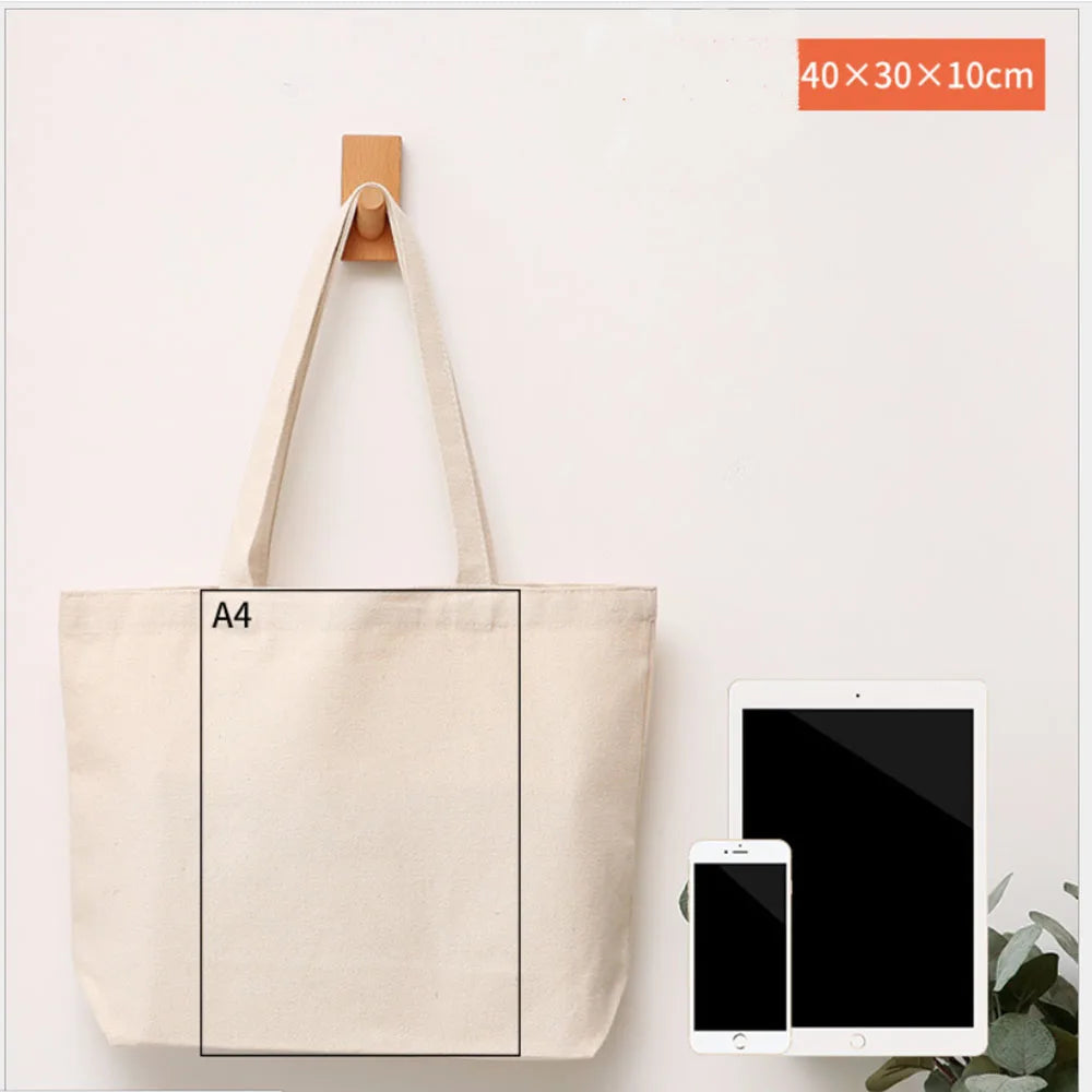 A beige canvas tote bag with an A4 sized rectangular insert and a wooden hanger shown against a white background.