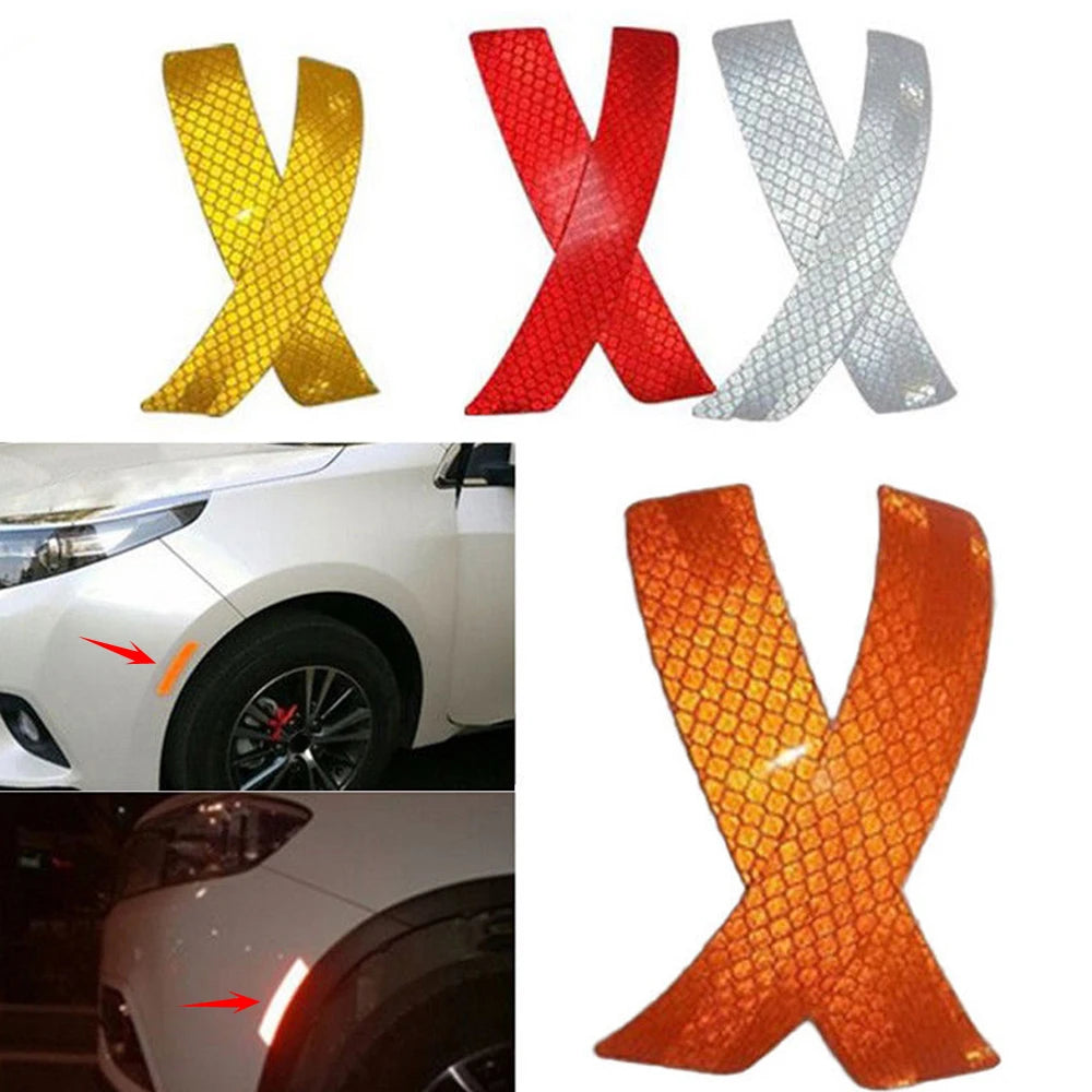 A set of three reflective X-shaped safety stickers in yellow, red, and silver for car fenders.