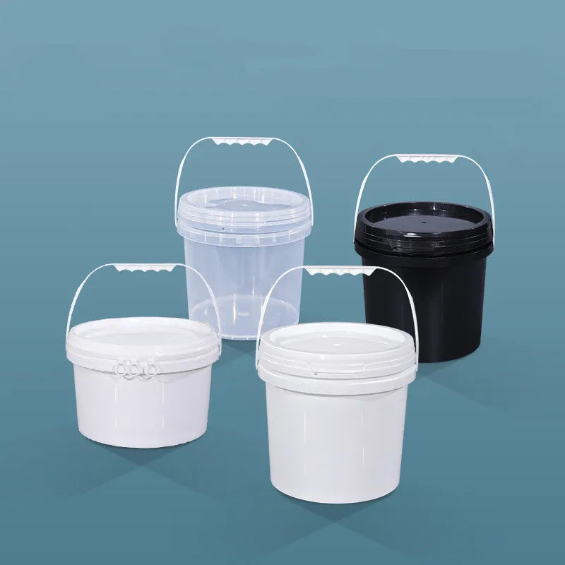 A set of two clear and black food-grade plastic buckets with leakproof lids on a blue surface.