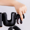 A hand is adjusting the cup holder mechanism on a black universal stroller cup and phone holder device.