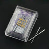 A clear plastic box containing a multi-pack of sewing machine needles with purple tint.