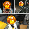 Close-up of an orange star design shift knob mounted in a vehicle interior.