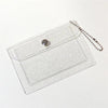 Clear glitter PVC card holder with a silver charm and attached chain.