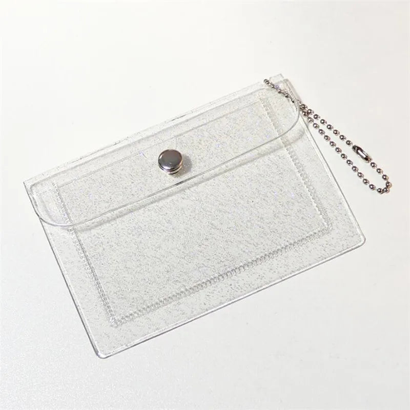 Clear glitter PVC card holder with a silver charm and attached chain.