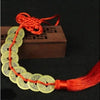 Chinese Feng Shui wealth coins with gold-colored coins strung on a red handmade knot