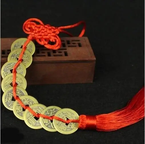 Chinese Feng Shui wealth coins with gold-colored coins strung on a red handmade knot