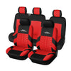 Four black car seat covers with red accents and headrests displayed together.