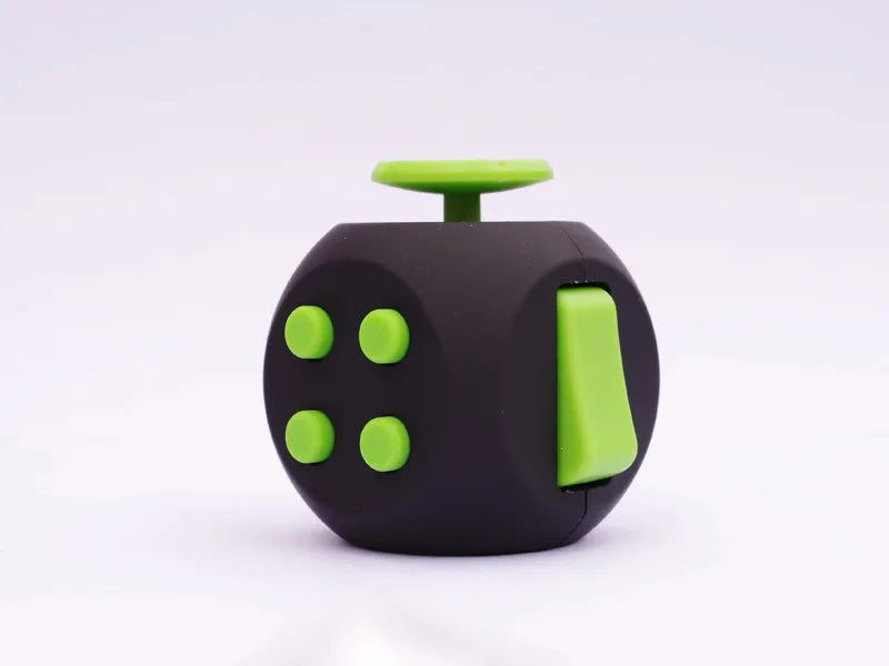 A black fidget cube with a lime green top and four round green buttons.