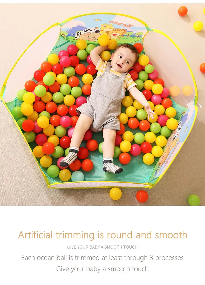 A colorful ocean-themed soft play pit filled with round balls in various bright colors for toddlers.