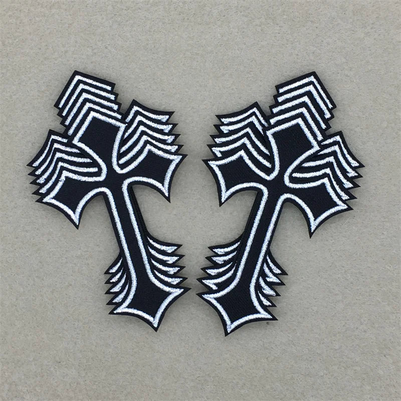 A set of ten black and white embroidered cross iron-on patches.