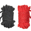 A pair of thick braided ropes, one black and one red, used for bondage or roleplay.