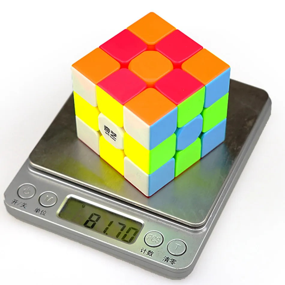 A colorful 3x3 speed cube puzzle resting on a digital scale.