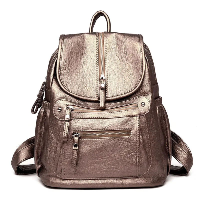 A brown faux leather women's backpack with multiple compartments shown from the back.