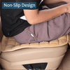 A close-up of a car seat cover with a non-slip design being placed onto a beige padded seat.