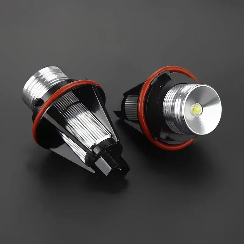 A pair of LED Angel Eyes marker light bulbs with silver and black housing and red accents.