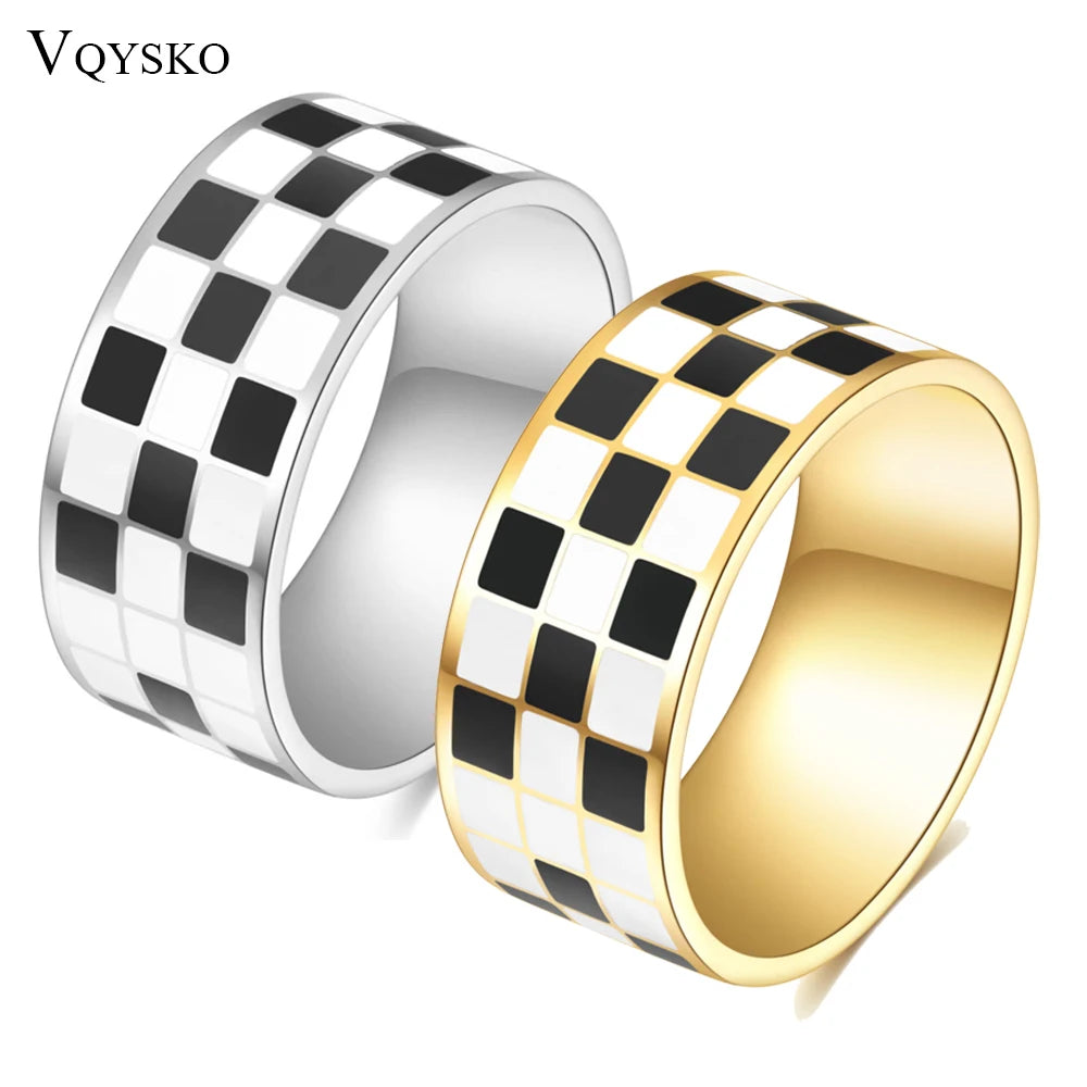A stack of chunky ring featuring a black and white checkerboard pattern on silver and gold metal.