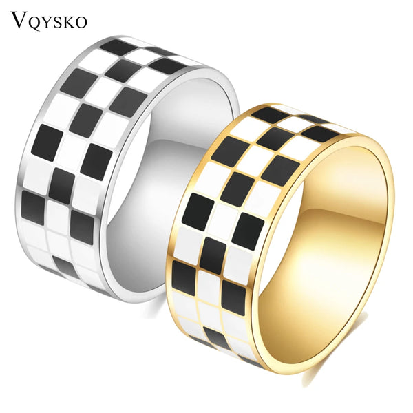 A stack of chunky ring featuring a black and white checkerboard pattern on silver and gold metal.