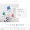 A collection of light blue and white suction cup hooks for kitchen or bathroom use.