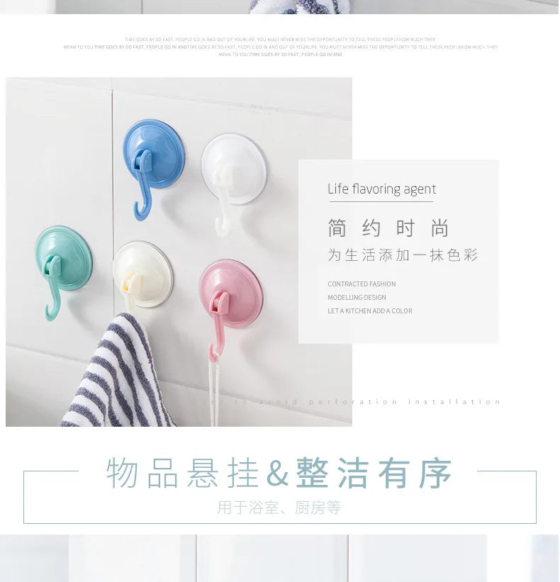 A collection of light blue and white suction cup hooks for kitchen or bathroom use.