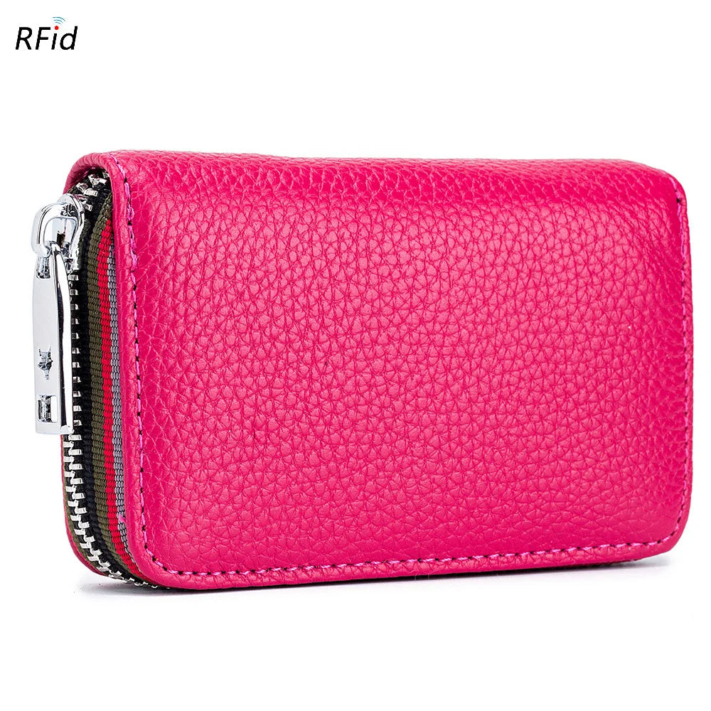 A vibrant pink genuine leather card holder with a zipper closure and RFID protection feature.