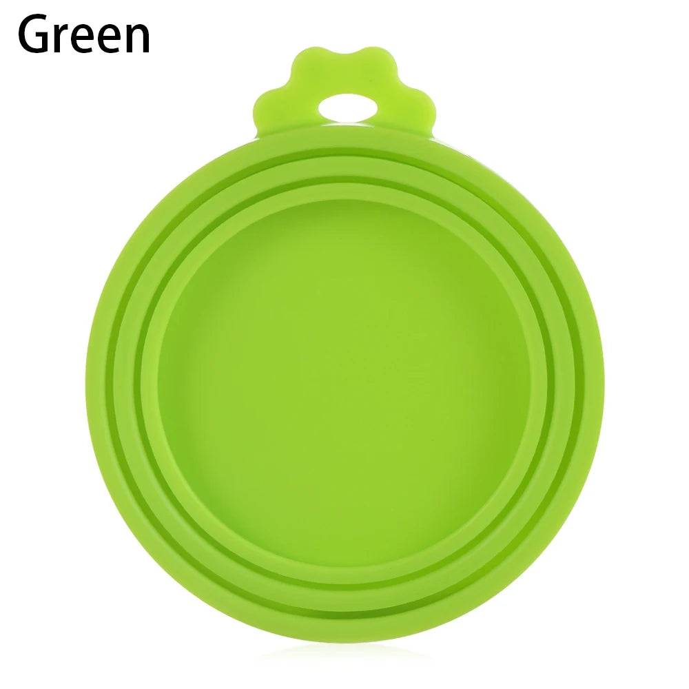 A bright green reusable silicone food storage lid with a handle.