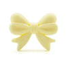 A pale yellow food-grade silicone bow or crown bead for jewelry making and DIY crafts.