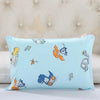 Light blue cartoon pillow featuring dinosaurs and vehicles