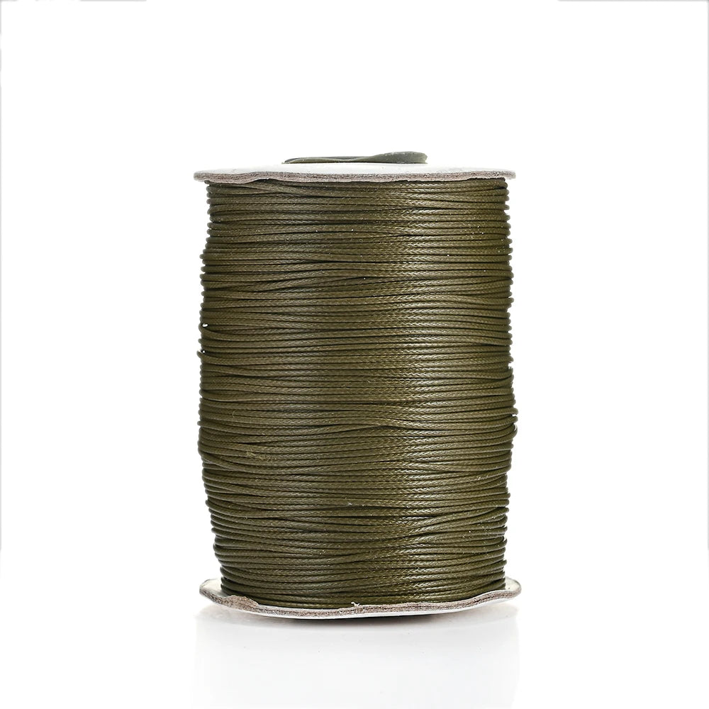 A spool of olive green waxed cotton cord used for jewelry making.