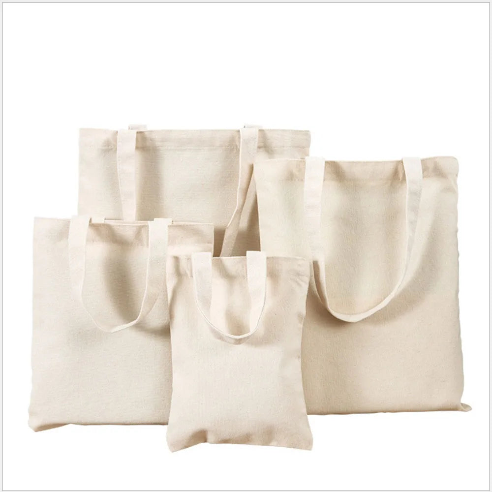 A collection of light beige canvas tote bags displayed together.