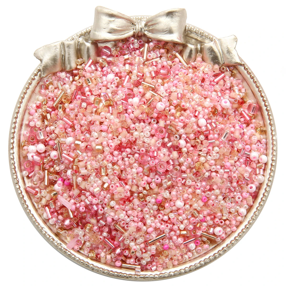 A circular dish filled with pink and clear glass seed beads tied with a bow for jewelry making