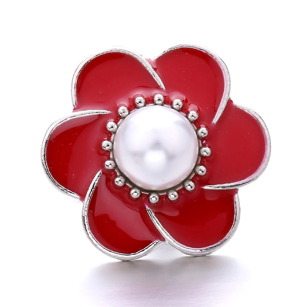 A vibrant red flower shaped metal snap button with a white pearl center for jewelry making.