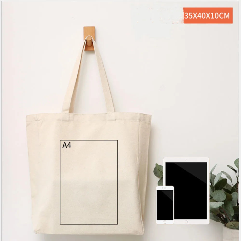 A beige canvas tote bag with a black square label is displayed against a white background.