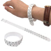 A hand is wearing a white measuring bracelet and a brown leather bracelet, with a separate white measuring tape shown below.