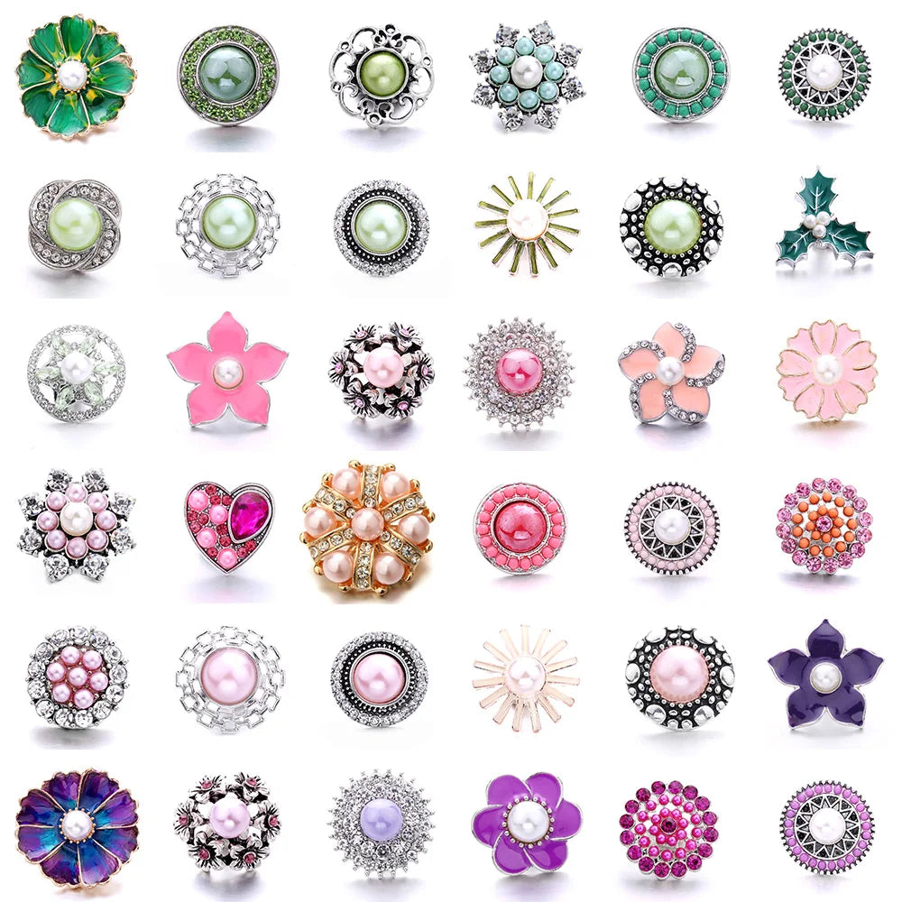 A collection of various decorative metal snap buttons and jewelry findings in different shapes, colors, and finishes.