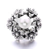 Silver metal snap buttons for jewelry making featuring a central pearl surrounded by floral designs