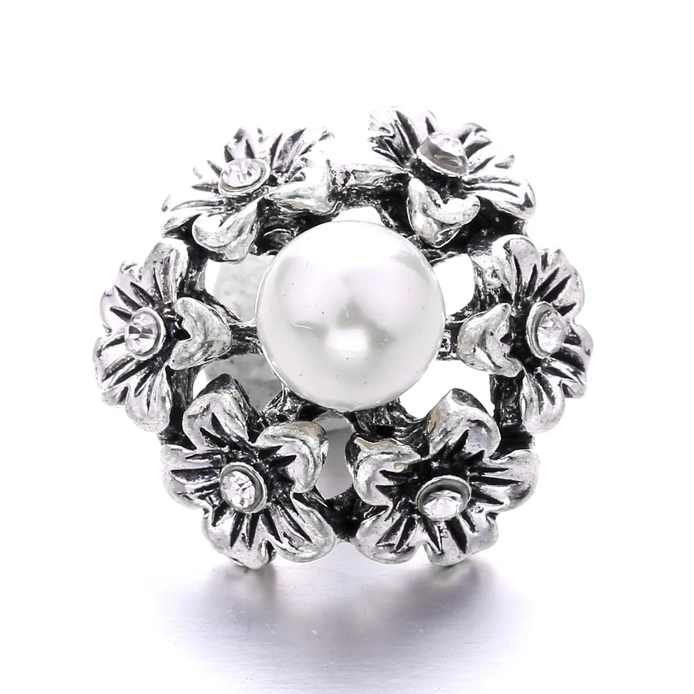 Silver metal snap buttons for jewelry making featuring a central pearl surrounded by floral designs