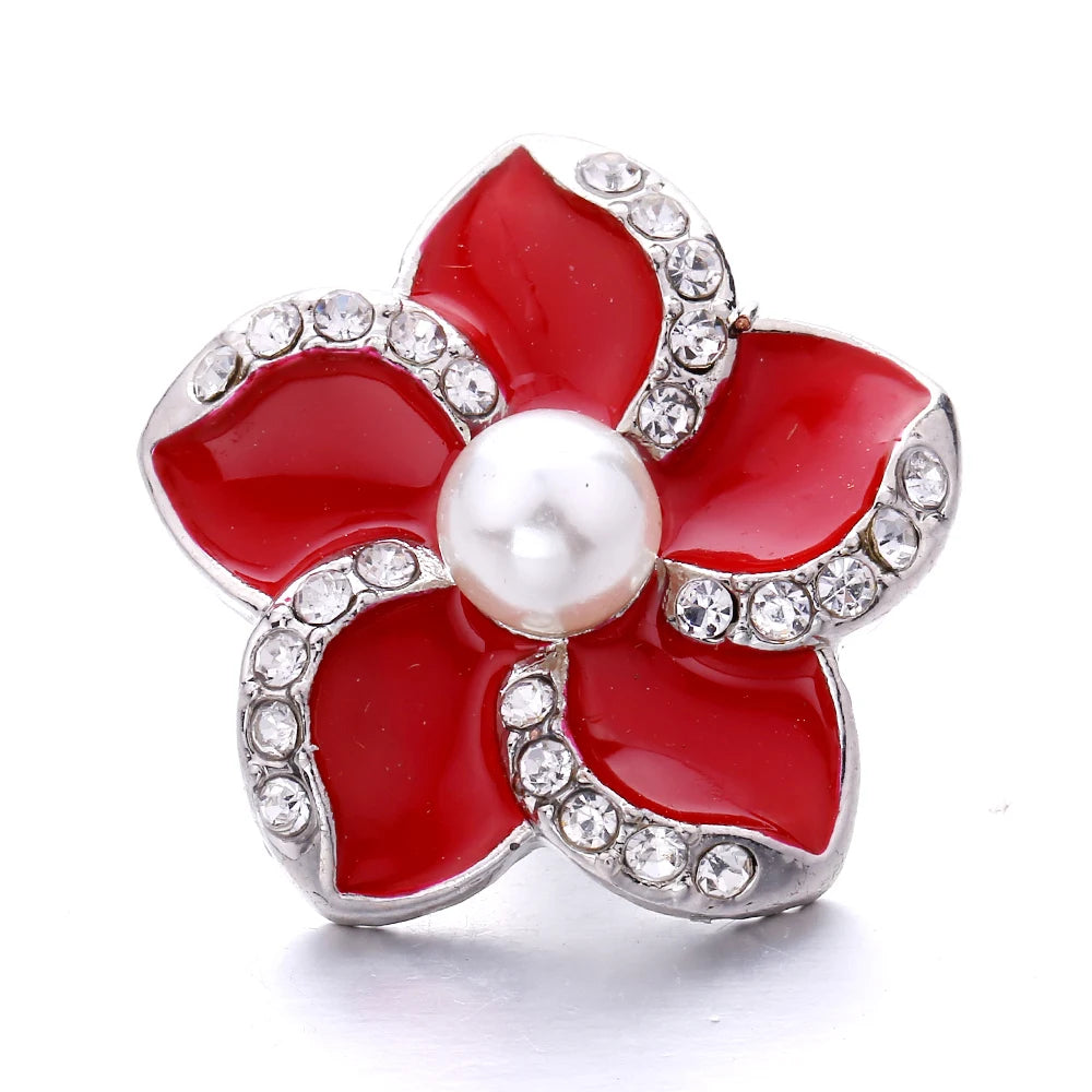 A red flower snap button with a pearl center and silver-toned metal setting for jewelry making