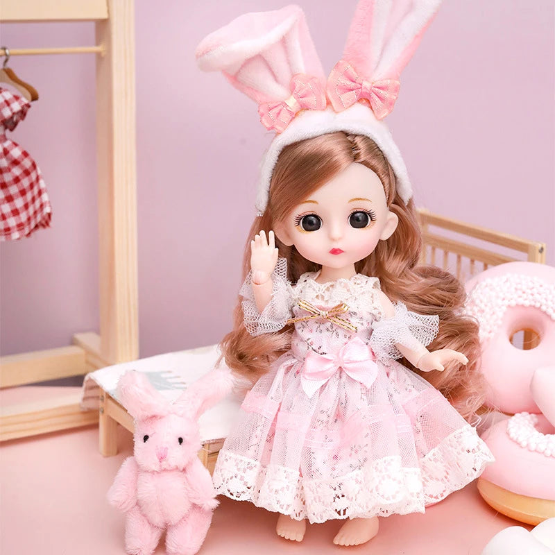 A pink fashion doll with long brown hair wearing a lace dress and a pink bow, standing next to a small pink rabbit.